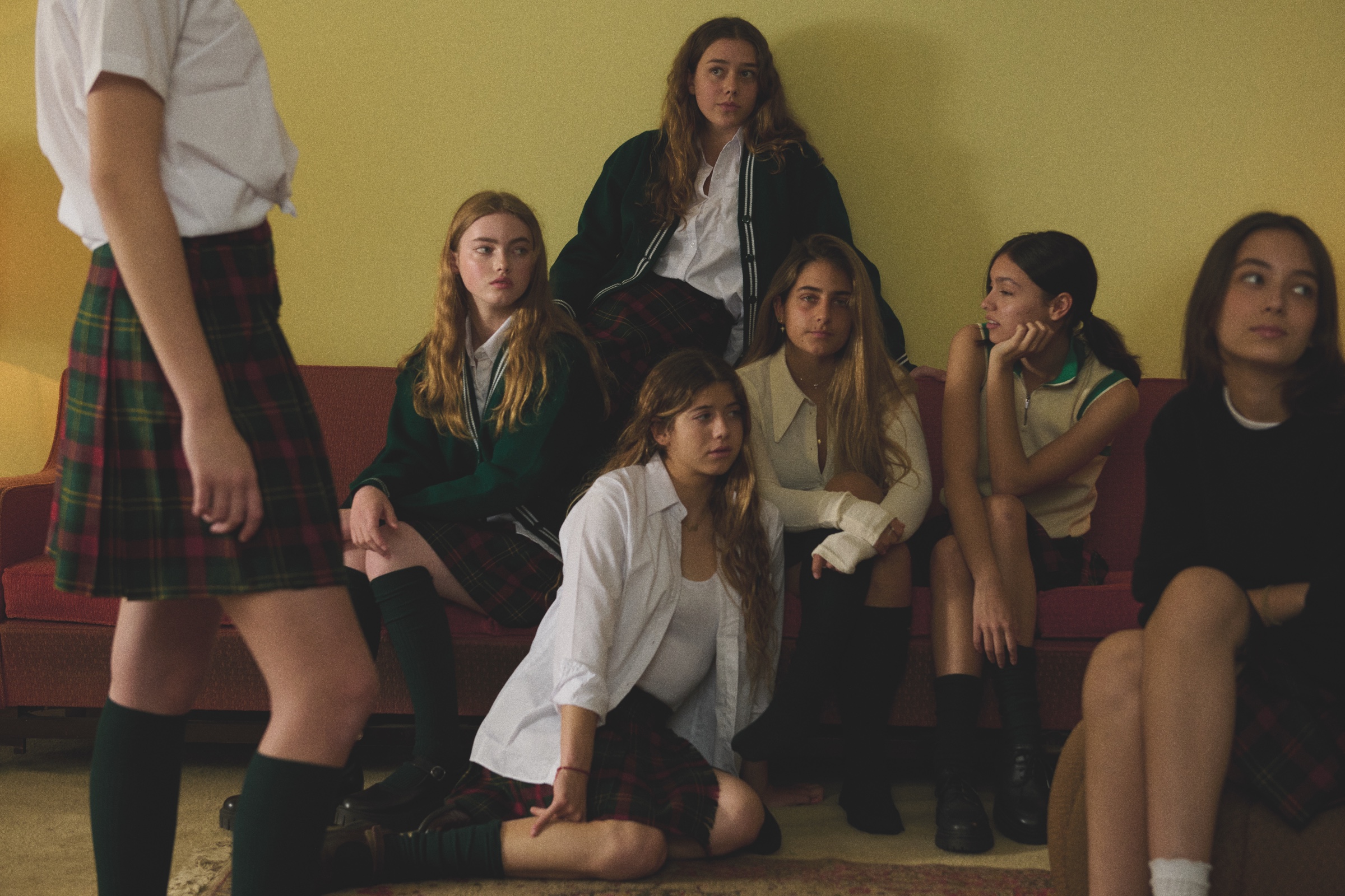 A group of students gathers in a living room.